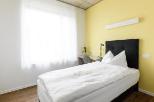 Postel nebo postele na pokoji v ubytování Partner Hotel AG Zofingen