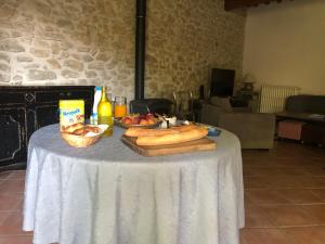a table with bread and food on top of it at B&B - Le Vieux Figuier in Vacqueyras