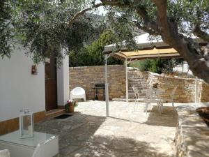 a patio with an umbrella and a table and chairs at Villa Rossana in Scopello
