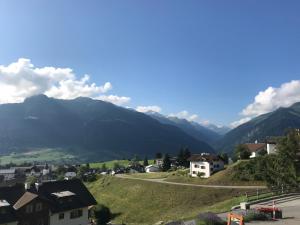 a view of a village with mountains in the background at Ustria / Pensiun Trutg in Vella