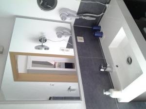 a bathroom with a sink and a mirror at Ferienhaus Schloss-Garten in Kapellen-Drusweiler