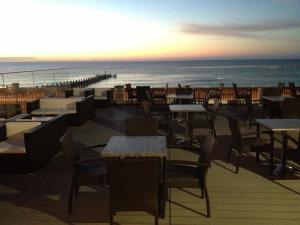 ローストフトにあるBest Western Hotel Hatfieldの海とテーブルと椅子が備わるレストラン