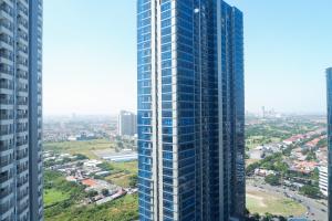 an aerial view of a tall building in a city at Clean Studio Apartment Connected to Mall at Orchard Supermall Mansion By Travelio in Surabaya