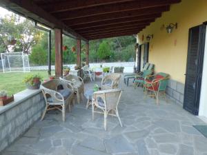 a patio with chairs and tables on a building at Casetta dei "Prati" in Vaglio di Basilicata