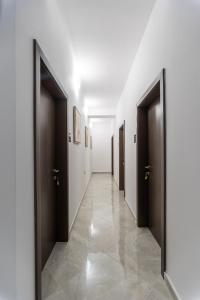 a hallway with two doors and a tile floor at Premium Inn in Gevgelija