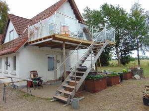 a house with a staircase leading up to a balcony at Verstvej bed and brekfast in Egtved