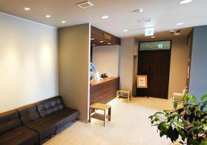 a lobby with a couch and a waiting room at Hotel Trend Okazaki Ekimae in Okazaki