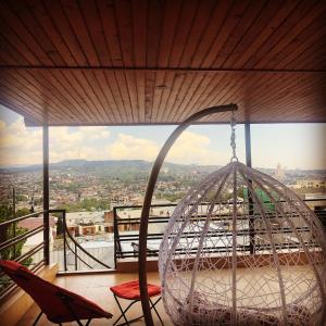 a glass swing hanging from the ceiling of a balcony at Villa Anna in Tbilisi City
