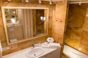 a bathroom with a sink and a mirror at Antakalnis 5 stars apartment in Vilnius +32 photos