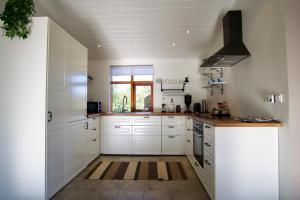 A kitchen or kitchenette at Harpa Holiday Home - Birta Rentals