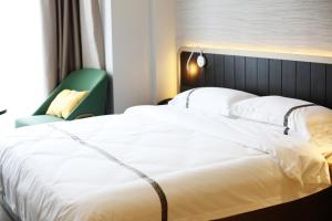 Voodi või voodid majutusasutuse Hangzhou Yuqi Hotel - West Lake Scenic Area Branch toas