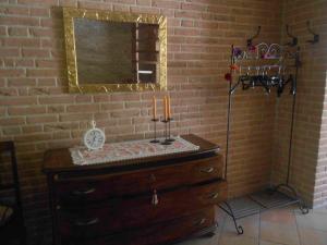 a bathroom with a sink and a mirror on a brick wall at A Casa Di Pici in Porto Potenza Picena