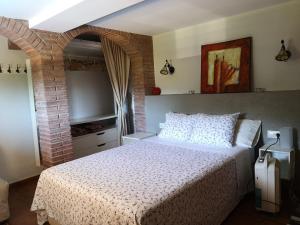 a bedroom with a bed and a brick wall at Casita con piscina y barbacoa privada in Blanes