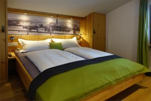 a bedroom with a large bed with a wooden headboard at Ferienwohnungen Schmidbauer in Fischen