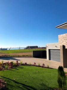 a view of a house with a grass yard at Lake Resort on Black Bull in Yarrawonga
