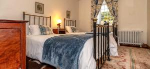 A bed or beds in a room at Mill Of Nethermill Holidays 