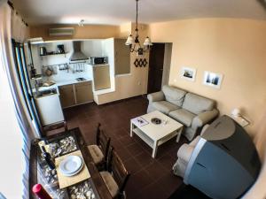 a small living room with a couch and a table at Seaview Symphony Appartments-Filia in Mochlos
