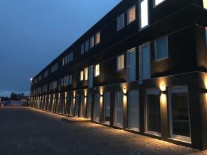 a black building with lights on the side of it at Hotell Norrort in Vallentuna