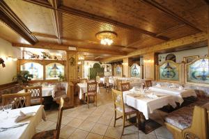 a restaurant with tables and chairs in a room at Chalet Piereni in Fiera di Primiero