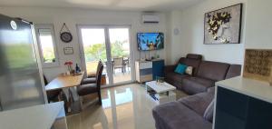 a living room with a couch and a table at Sunset Apartment in Mandre