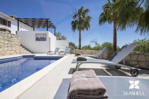 a luxury villa with a swimming pool and a resort at Villa Angel in Loulé