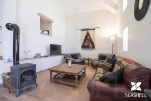 a living room with a couch and a fireplace at Villa Angel in Loulé