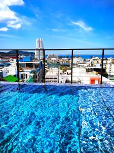 a large swimming pool on the roof of a building at Phoenix Grand Patong in Patong Beach