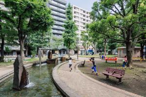 a group of children playing in a park at Park Residence Omori in Tokyo