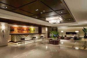 a lobby of a hotel with tables and chairs at Royal Hotel Seoul in Seoul