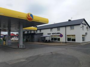 a gas station with a large yellow and white building at U Szelca in Krosno