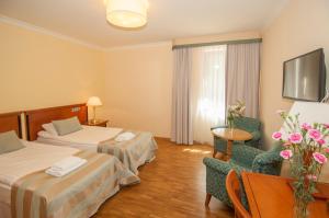 Łóżko lub łóżka w pokoju w obiekcie Hotel Mir-Jan SPA