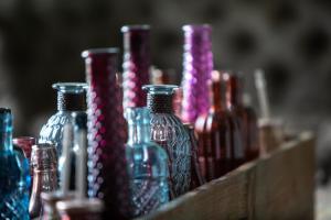 a bunch of glass bottles in a wooden box at Elan Hotel in Limburg an der Lahn