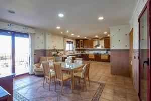 a kitchen and dining room with a table and chairs at Casa Peseta, Casa Rural in Vallada