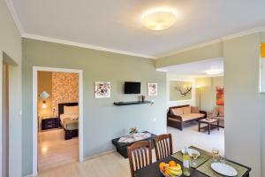 a living room with a dining table and a living room at Poseidon Apartments in Kato Daratso