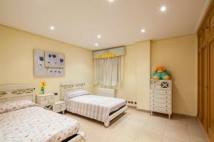 a bedroom with two beds and a window at Casa Peseta, Casa Rural in Vallada +166 photos