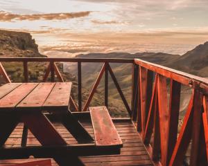 Un banco de madera situado encima de una plataforma de madera. en Sani Mountain Escape, en Mokhotlong