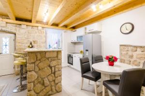a kitchen and dining room with a table and chairs at Apartment Little Star II in Dubrovnik