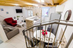 a kitchen and a living room with a table at Apartment Little Star II in Dubrovnik