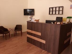 a counter with two chairs and a table in a room at Hotel Trifylia in Kyparissia