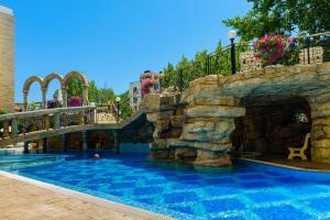 a pool in a resort with a water slide at Sweet Homes Apartments in Sunny Beach