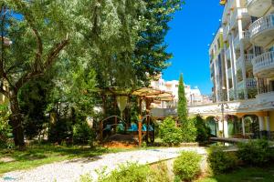 a park in front of a building with a playground at Sweet Homes Apartments in Sunny Beach