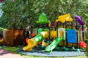 a playground with a slide in a park at Sweet Homes Apartments in Sunny Beach