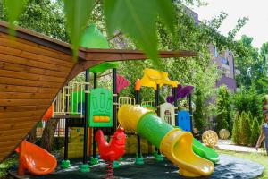 a playground with a slide in a park at Sweet Homes Apartments in Sunny Beach