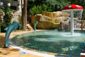 a fountain with two dolphins in a pool at Sweet Homes Apartments in Sunny Beach
