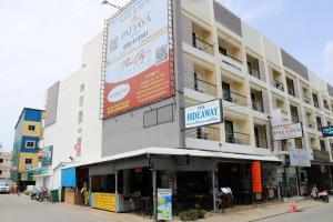 a building with a sign on the side of it at Hideaway Guest House And Bar in Pattaya