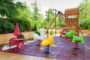 a playground with colorful play equipment in a backyard at Sweet Homes Apartments in Sunny Beach