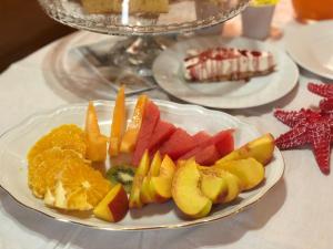 a plate of fruit on top of a table at La marina in Cagliari +55 photos