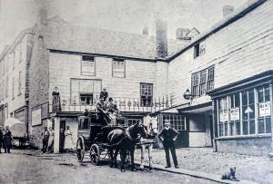 a black and white photo of a horse drawn carriage at The Darlington in Camelford
