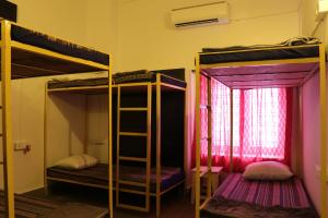 a room with two bunk beds and a window at Shepherd Stories - Community stay for Social Entrepreneurs in Hyderabad