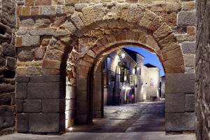 an archway in a stone building with a street at Hotel Arco San Vicente in Ávila